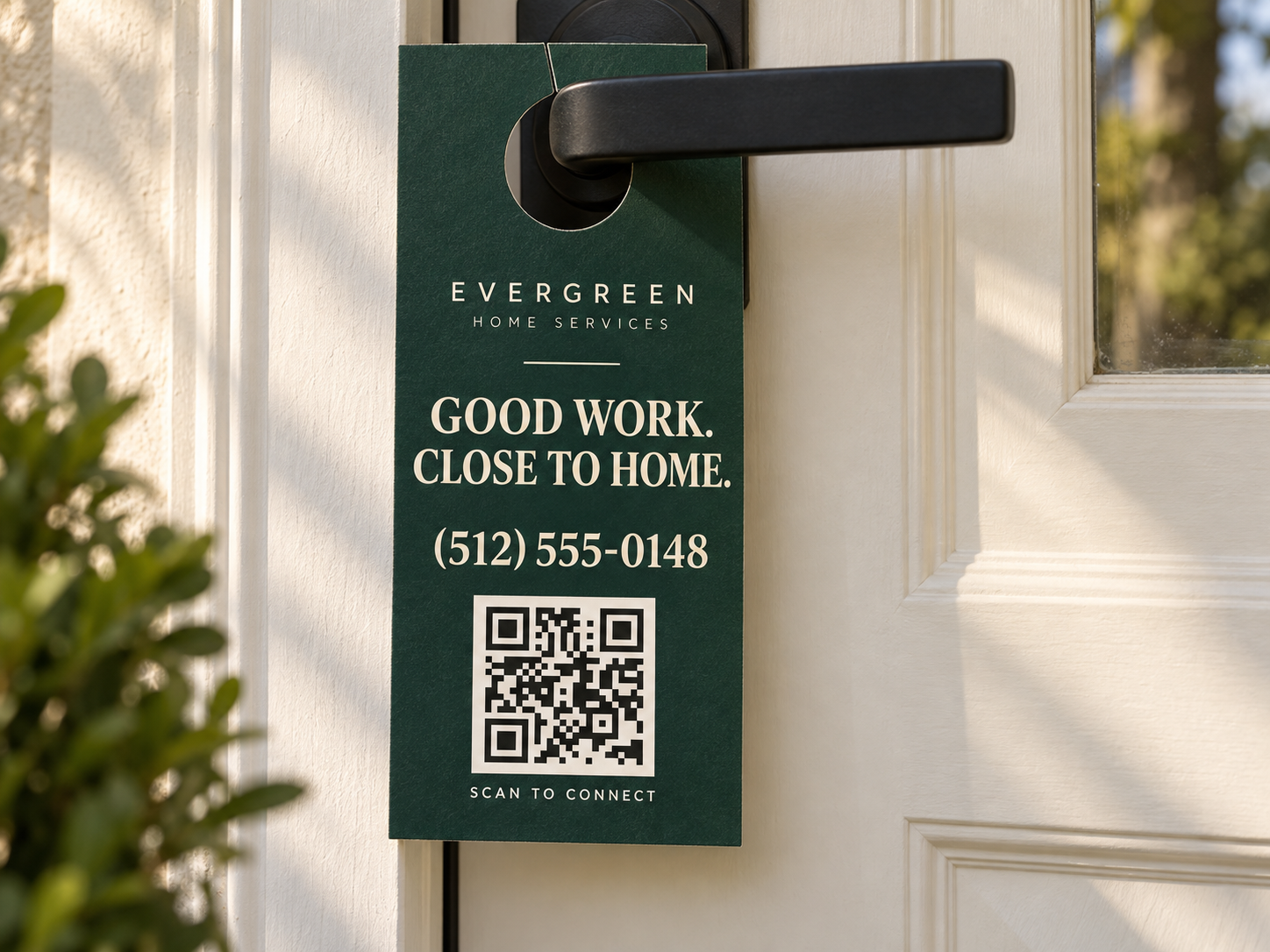 Example Evergreen Home Services door hanger on a door handle, with a phone number and a QR code